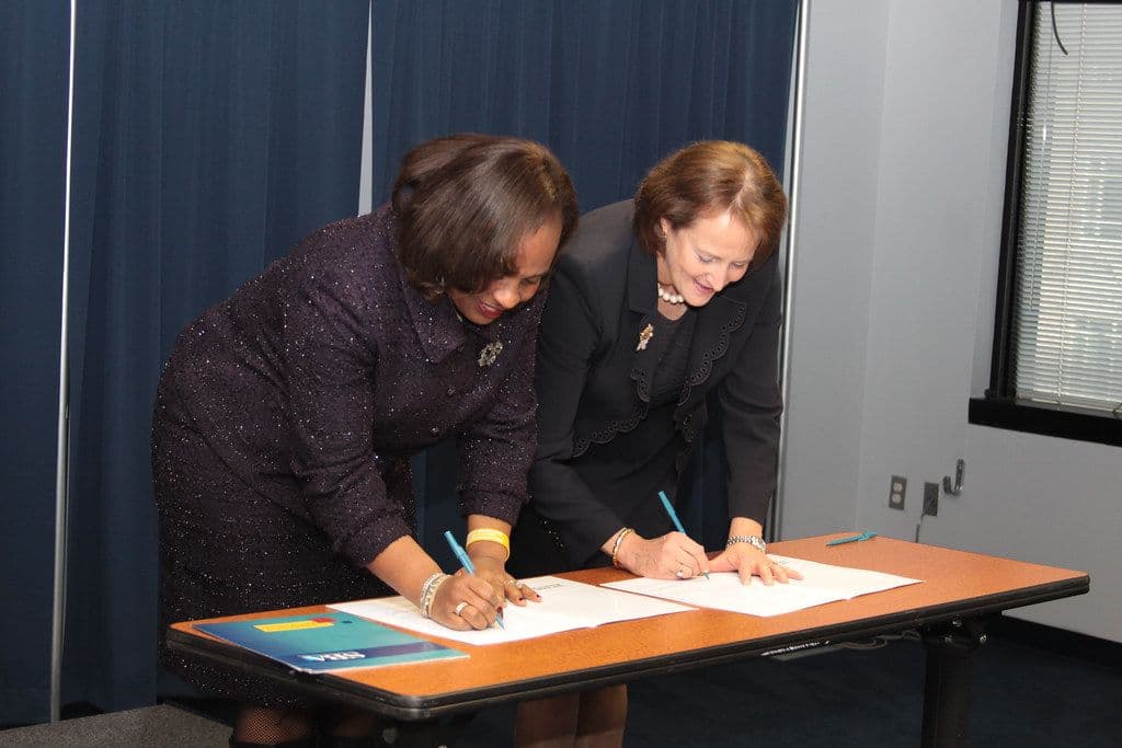 Signing business paperwork at a desk