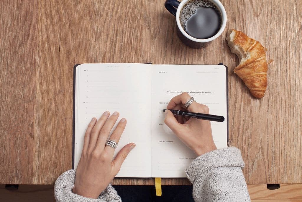 A planner and notebook on a desk