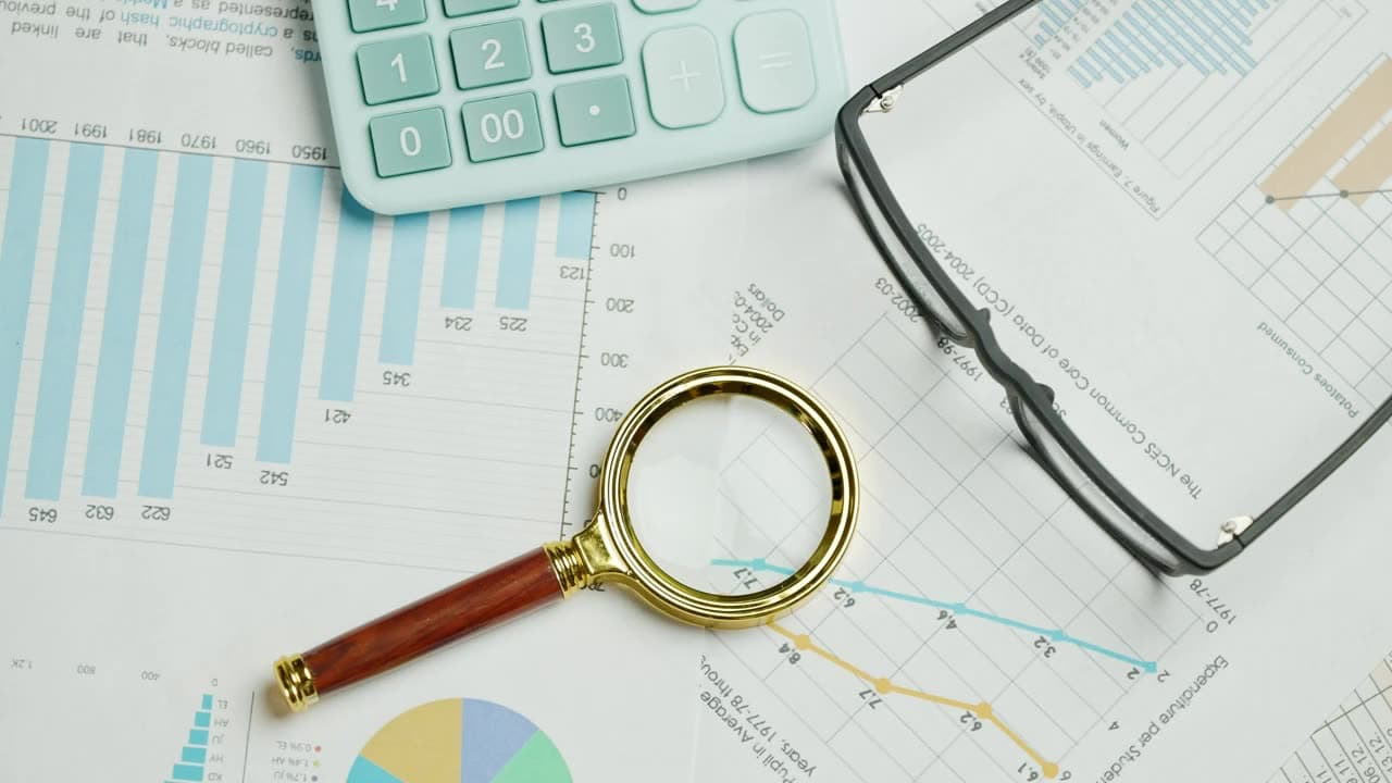 Business documents and a magnifier on a desk