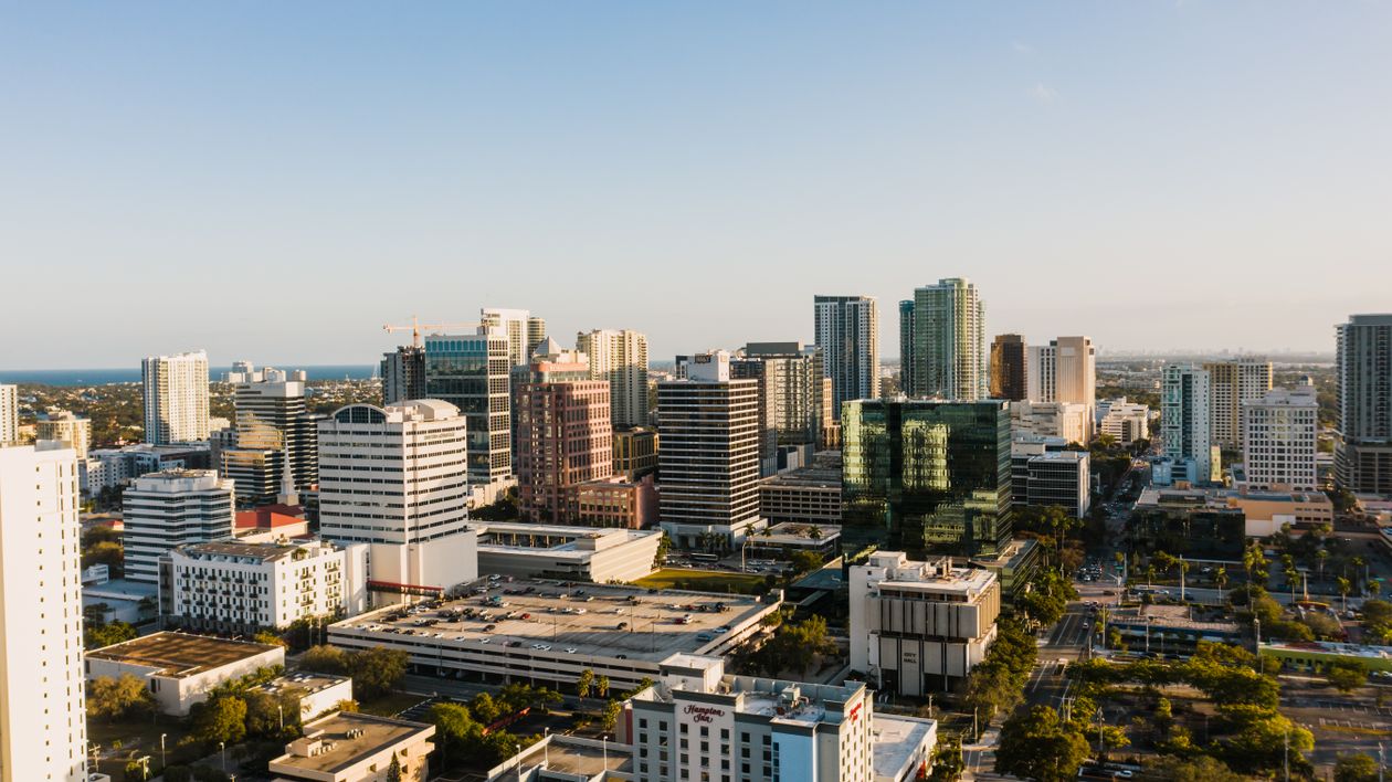 Aerial view of modern urban commercial district with office buildings and tree-lined streets