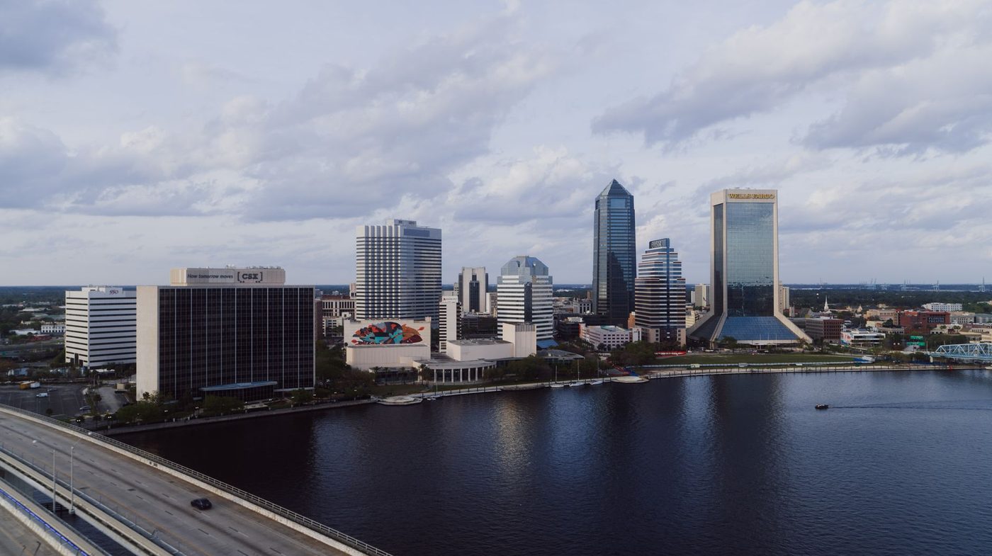 Aerial view of Jacksonville's skyline and the St. Johns River under cloud cover