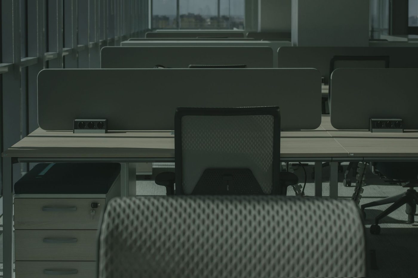 Empty office space with bare desks and windows