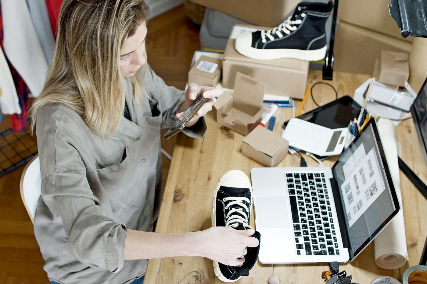 Small business owner working at a laptop in a bright storefront office
