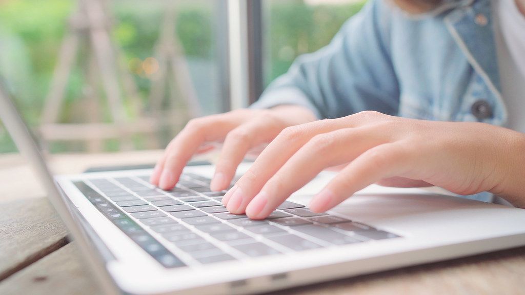 A small business owner working on a laptop