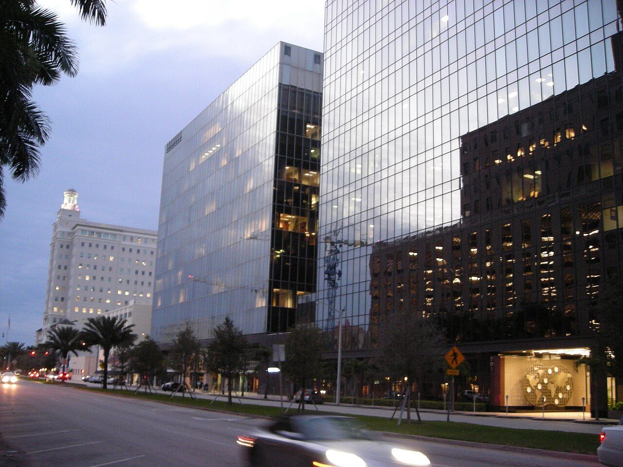 Office towers along a boulevard at dusk in Coral Gables