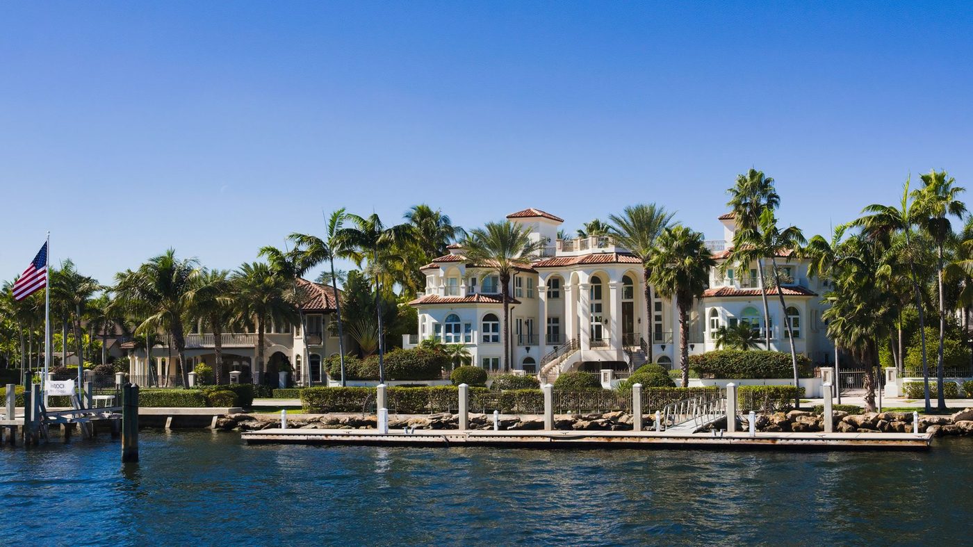 Waterfront estates with palm trees along the Intracoastal Waterway in Palm Beach County