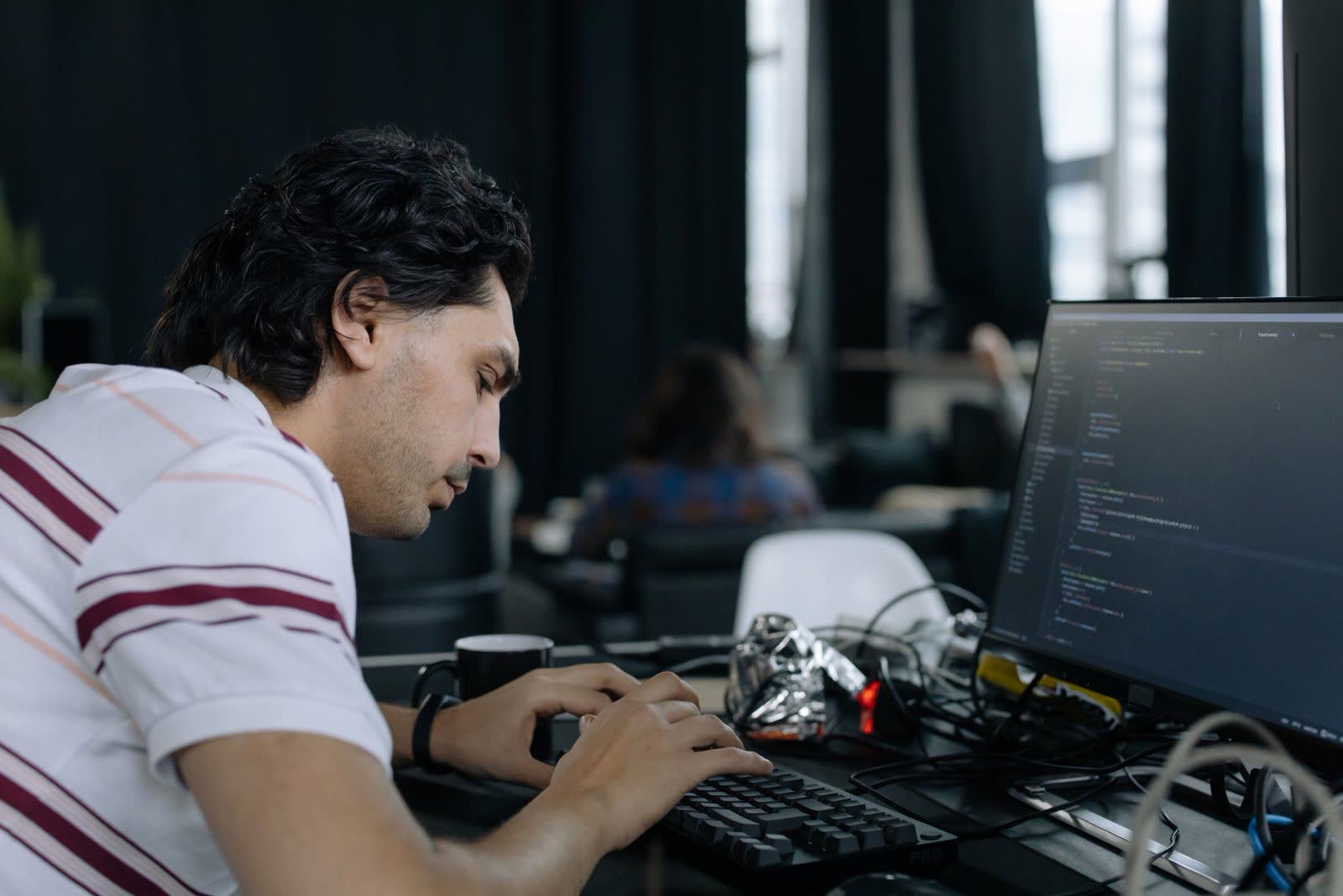 Developer concentrating at a workstation keyboard