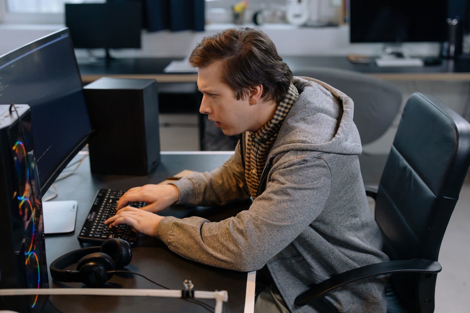 Developer working at a desktop monitor in an office