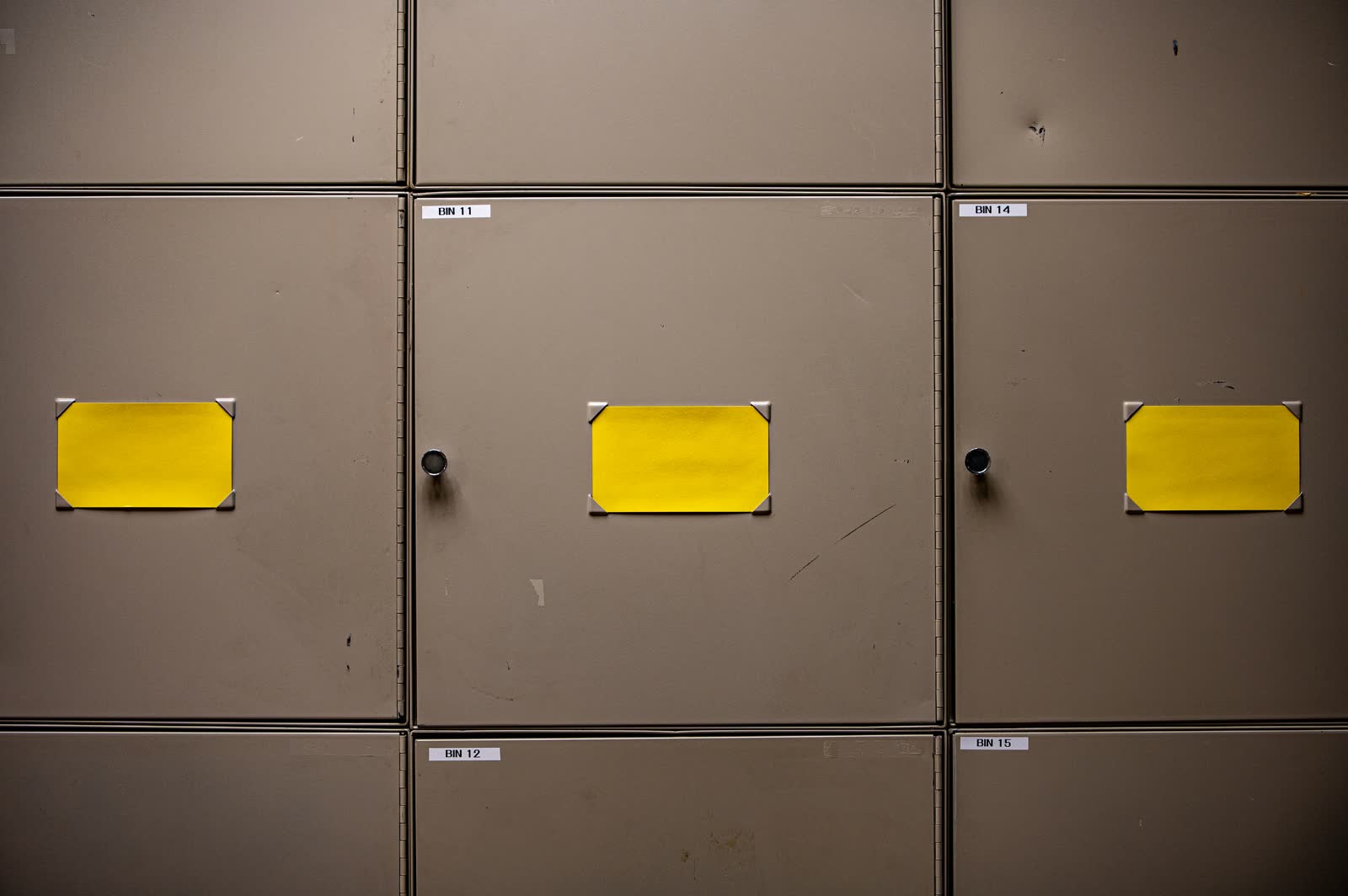 Rows of steel storage cabinets, each door carrying its own numbered label